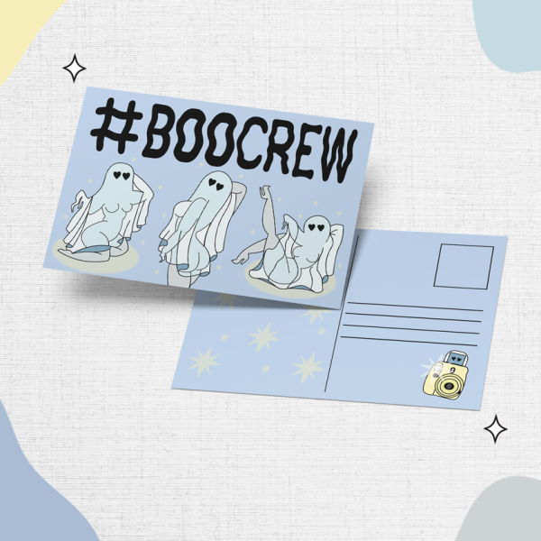 A postcard on a textured background displays the hashtag "#BOOCREW" with illustrations of cute, playful ghosts. The back of the postcard is visible, showing space for an address and a stamp. There is also a small illustration of a camera in the bottom right corner.