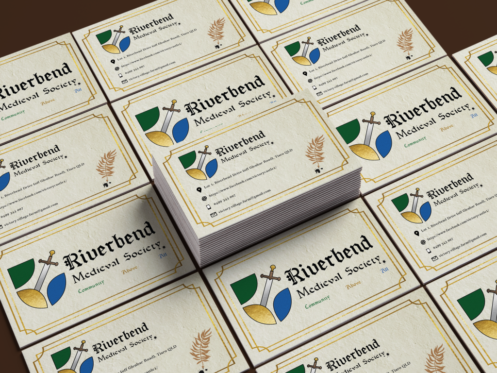 A stack of business cards for the Riverbend Medieval Society arranged in a grid pattern. The cards display a coat of arms featuring a sword, shield, and goblet, along with contact details: a phone number, email, and address. The design includes medieval-style fonts and a laurel leaf.