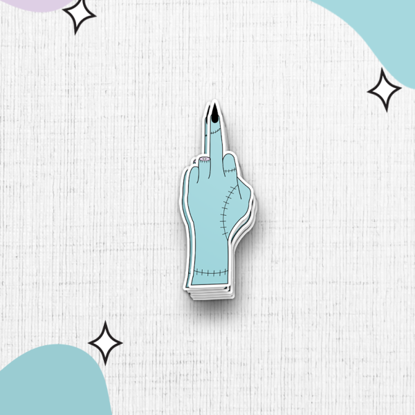 A turquoise, stitched cartoon hand sticker, with an extended middle finger, set against a white textured background. The hand is surrounded by abstract blobs of pastel colors and small star-shaped accents.