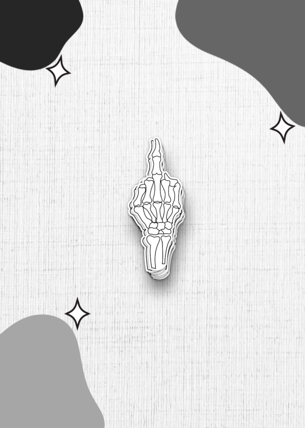 A skeleton hand sticker is a minimalist black and white illustration depicting a skeleton hand giving the middle finger, set against a white textured background. The corners of the image are adorned with abstract, irregular black and grey shapes and small star-like accents.