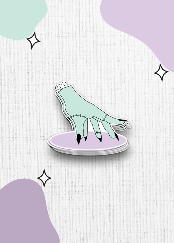 Illustration of a dismembered, stitched-together hand in a pale green hue with black nails, resting palm-down on a lavender oval. The background is white with textured patterns and abstract shapes in green and purple, complemented by small star-like sparkles.