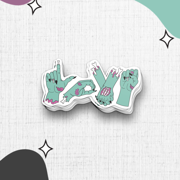 The Zombie Love sticker stack features the letters "LOVE" cleverly shaped by green zombie hands in various gestures. The backdrop showcases an array of abstract purple, green, and black shapes adorned with small black stars, creating a playful yet spooky atmosphere.