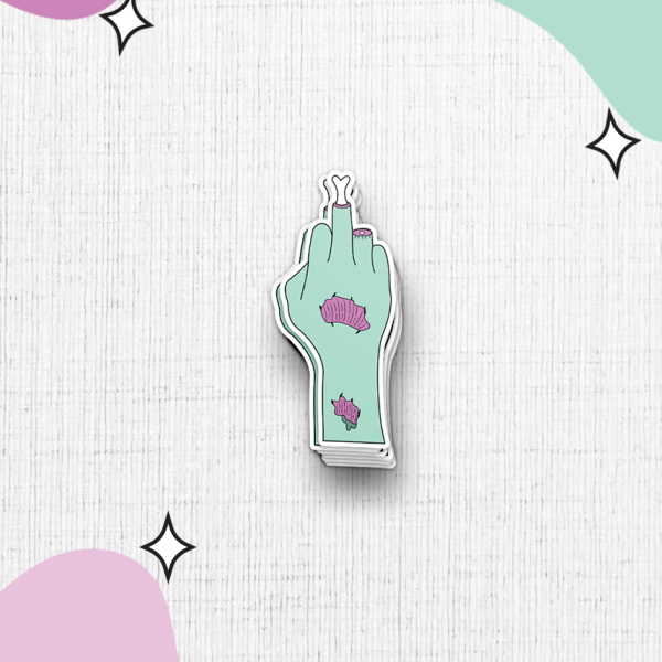 The sticker features a zombie hand showing the middle finger on a textured white background. The light green hand is adorned with pink peeling flesh. The background showcases abstract pastel pink and green shapes accompanied by small black star accents.