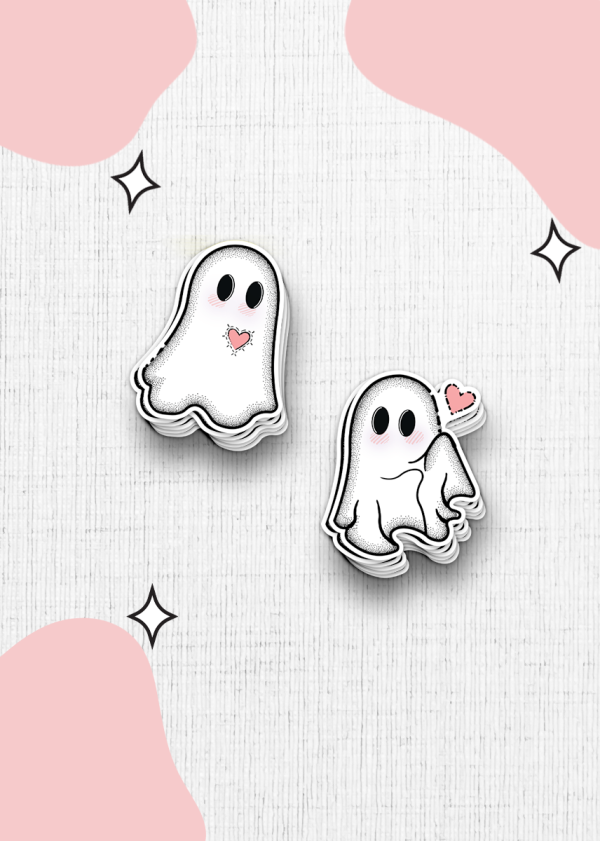 Two ghost cartoon stickers with rosy cheeks on a textured white background. One ghost is simple while the other is holding a pink heart with a wink. The background is decorated with soft pink blob shapes and small black star accents.